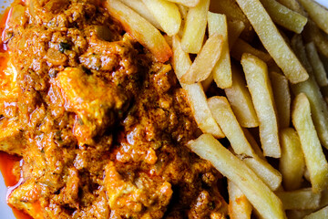  A Plate of Traditional Chicken Tikka Masala With Chips