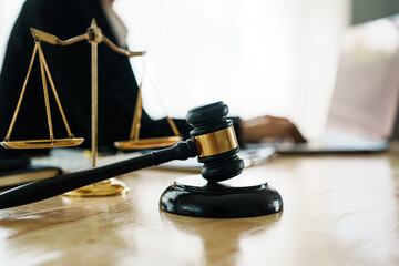 A professional lawyer advises a client in a legal office, reviewing contracts and justice symbols...