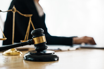 A professional lawyer advises a client in a legal office, reviewing contracts and justice symbols...