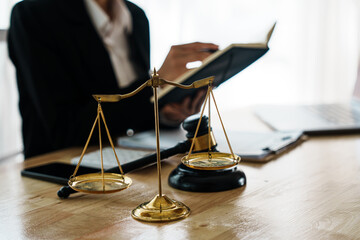 A professional lawyer advises a client in a legal office, reviewing contracts and justice symbols...