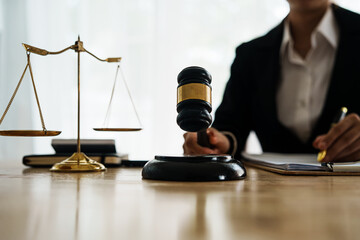 A professional lawyer advises a client in a legal office, reviewing contracts and justice symbols...