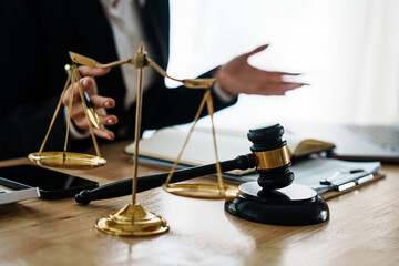 A professional lawyer advises a client in a legal office, reviewing contracts and justice symbols...