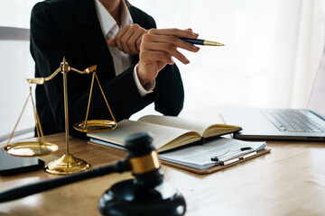A professional lawyer advises a client in a legal office, reviewing contracts and justice symbols...