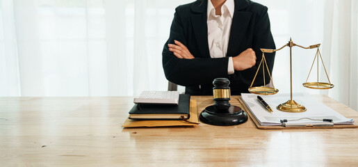 A professional lawyer advises a client in a legal office, reviewing contracts and justice symbols like a gavel and legal books