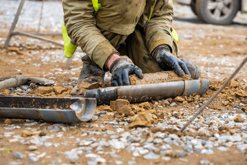Man cutting and cleaning soil sample for laboratory analysis. Preparation of core material for...