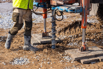 Close-up of soil sampling during pile drilling process. Extraction of subsurface material for...