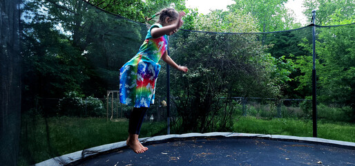 Girl hopping around on a trampoline