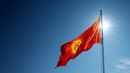 Celebration of kyrgyzstan's independence day with the national flag in clear blue sky