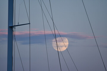 Tranquil Evening Sail with Full Moon and Masts in Serene Sky