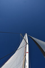 Stunning View of a Sailboat's Masts Against a Clear Blue Sky