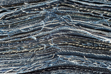 Texture from torn pieces of denim. Jeans texture. Material for sewing clothes
