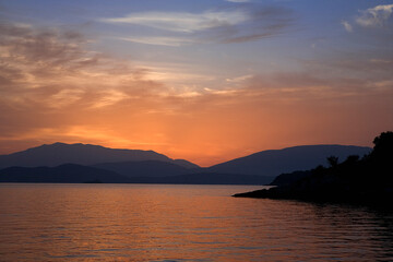 Fototapeta premium Dawn over the mountains of Albania, from Kassiopi in the north of Corfu (Kerkyra), Ionian Islands, Greece