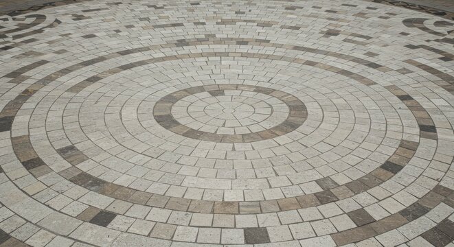 Circular stone pavement design with concentric circles and alternating light and dark colored bricks - Powered by Adobe