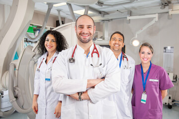 Team of Three Doctors and a Nurse in Hospital Operating Room with Scanner