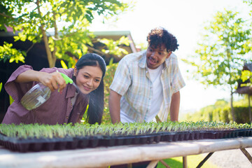Two high school students are studying and researching about planting and growth of plants and...