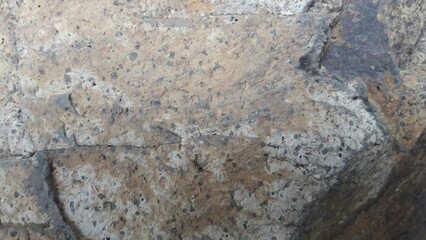 Weathered rock surface, close-up textured style, grey, brown, and beige colors, natural abstract background