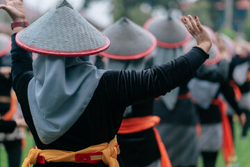 Cultural Dance Performance with Traditional Attire and Decorative Hats Outdoors