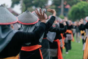 Cultural Dance Performance Featuring Traditional Hats and Synchronised Movements