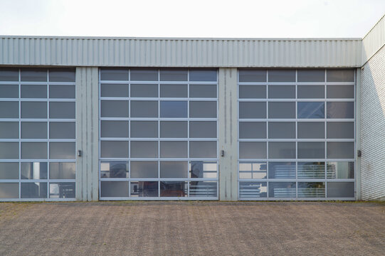 Three sectional garage doors showing industrial interior