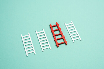 The red staircase stood out among the white ones. The best tool. The concept of financial services, lending and sponsorship. Excellence, selection, and smart financial planning.