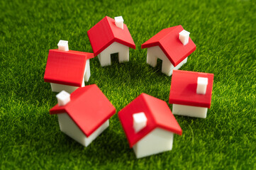 A circle of houses on the grass. Community of homeowners. Cooperatives of farms and summer cottages and other forms of cooperative management. Unity, community, or cooperative living.