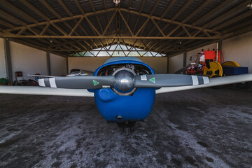 An airplane parked in a hanger. It's a aircraft on an airport