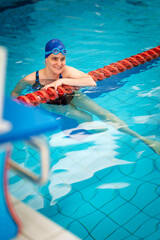 A visually impaired woman in swimming pool after training