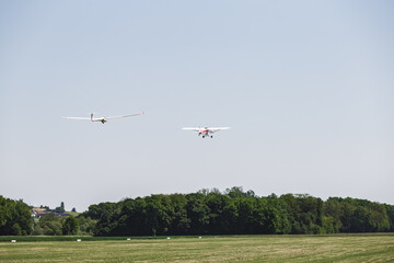 An airplane in fligt over a airfield. An aircraft for transportation in aviation
