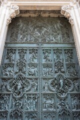 The decoration of the main gate of Duomo di Milano depicting biblical scenes