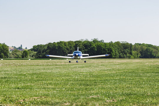 An airplane on a grass runway. The aircraft is ready to fly. It's a transportation for people