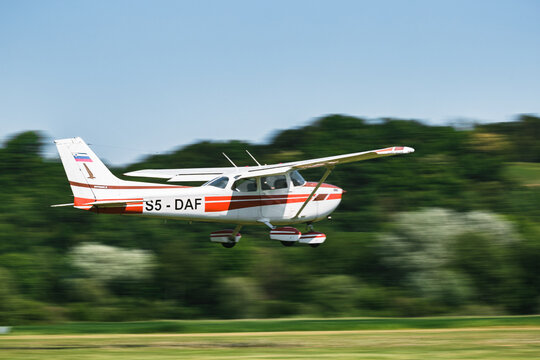 An airplane in fligt over a airfield. An aircraft for transportation in aviation