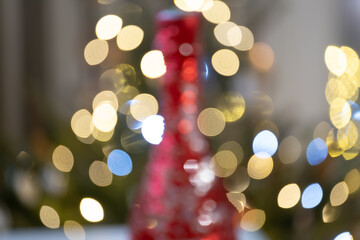A dreamy and artistic photo of warm bokeh Christmas lights in gold, yellow, and blue tones, with a...