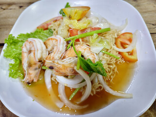 Spicy Seafood Instant Noodles Salad on White Plate. 