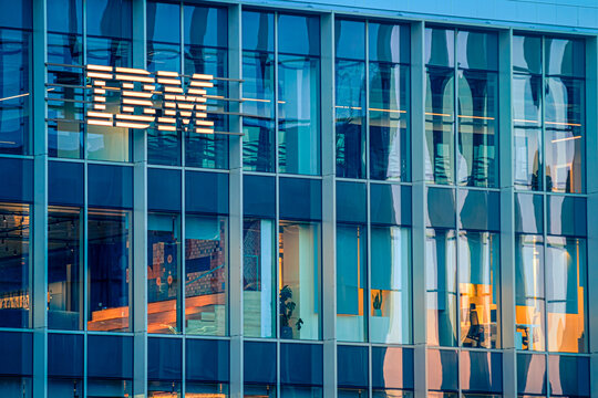 IBM office building at day with glowing logo and modern glass