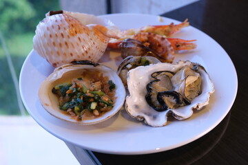 table set with assorted appetizers, seafood, and pastries for a festive meal