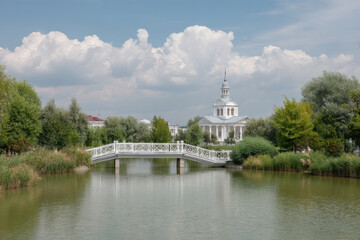 serene landscape of astrakhan featuring beautiful bridge over calm waters surrounded by lush greenery and clear
