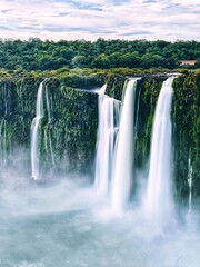 Majestic waterfall over lush green cliffs.