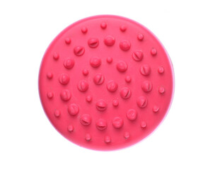 Red rubber massage brush with raised nodules isolated on white background