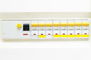 Multiple circuit breaker switches in residential electrical panel on white background