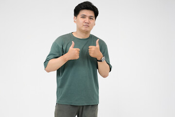 young asian man giving thumbs up for succeed in whtie background