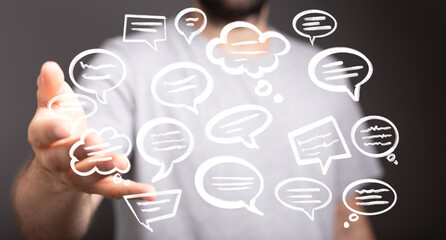 Image of a man's hand holding multiple digital speech bubbles, representing communication,...