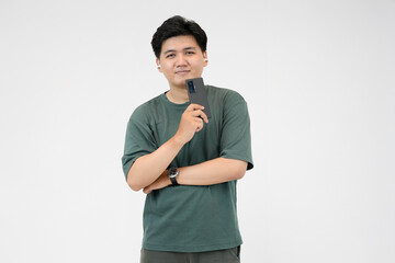 young asian man excited using smartphone and wearing earbuds in studio background