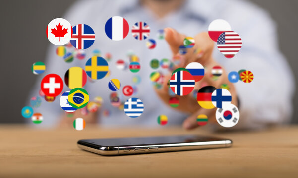 Person interacts with floating flags on a smartphone, symbolizing global communication and translation.