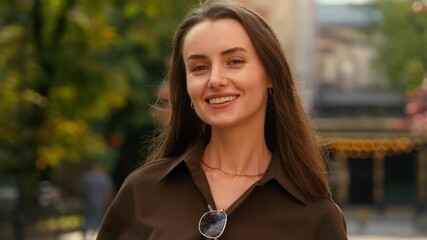 Portrait of happy smiling stylish Caucasian woman businesswoman female business girl at street autumn city looking at camera headshot carefree positive satisfied cheerful lady outdoors fashion style