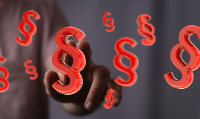 Abstract image of a hand interacting with floating 3D paragraph symbols, representing law, legal,...