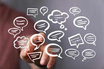 Hand interacting with digital speech bubbles,communication, conversation, ideas.