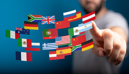 Image of a person interacting with digital flags representing international business and...