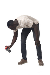 side view of a crouching man painting with a spray