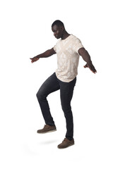 side view of a man balancing on one foot on white background