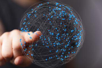 Abstract image of a hand interacting with a digital sphere representing global network connections.